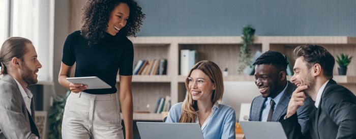 group of professional workers smiling and having a work discussion