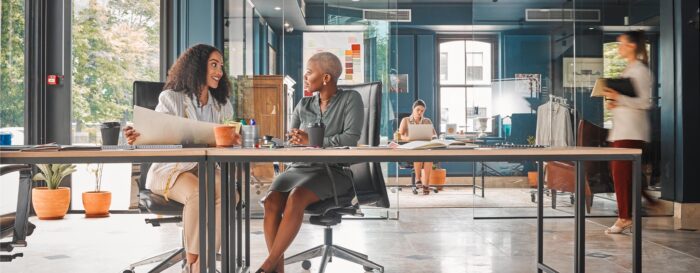 two business women sitting at a table having a discussion